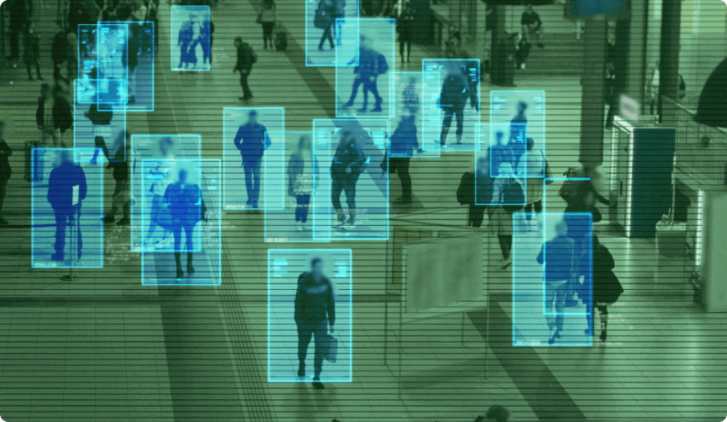 A security camera view of a crowd with a digital overlay tracking individuals, representing video analytics