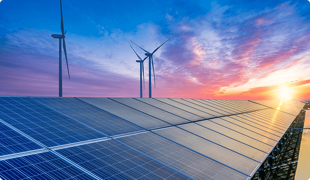 A solar panel array and wind turbines set against a vibrant sunset sky, symbolizing renewable energy