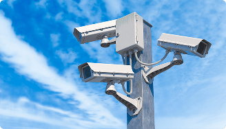 Multiple outdoor security cameras mounted on a pole